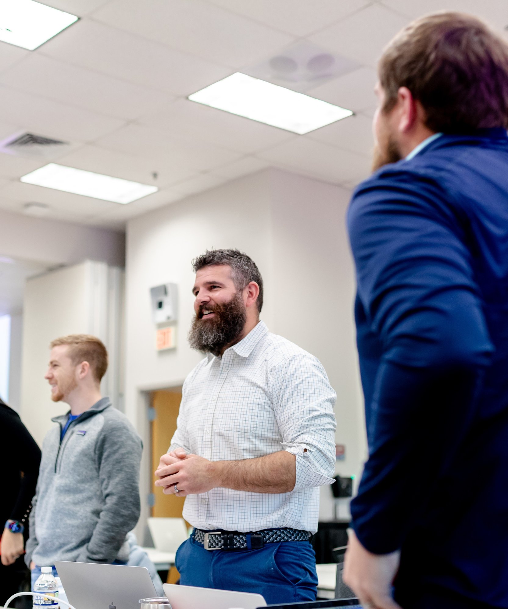Three men standing and smiling