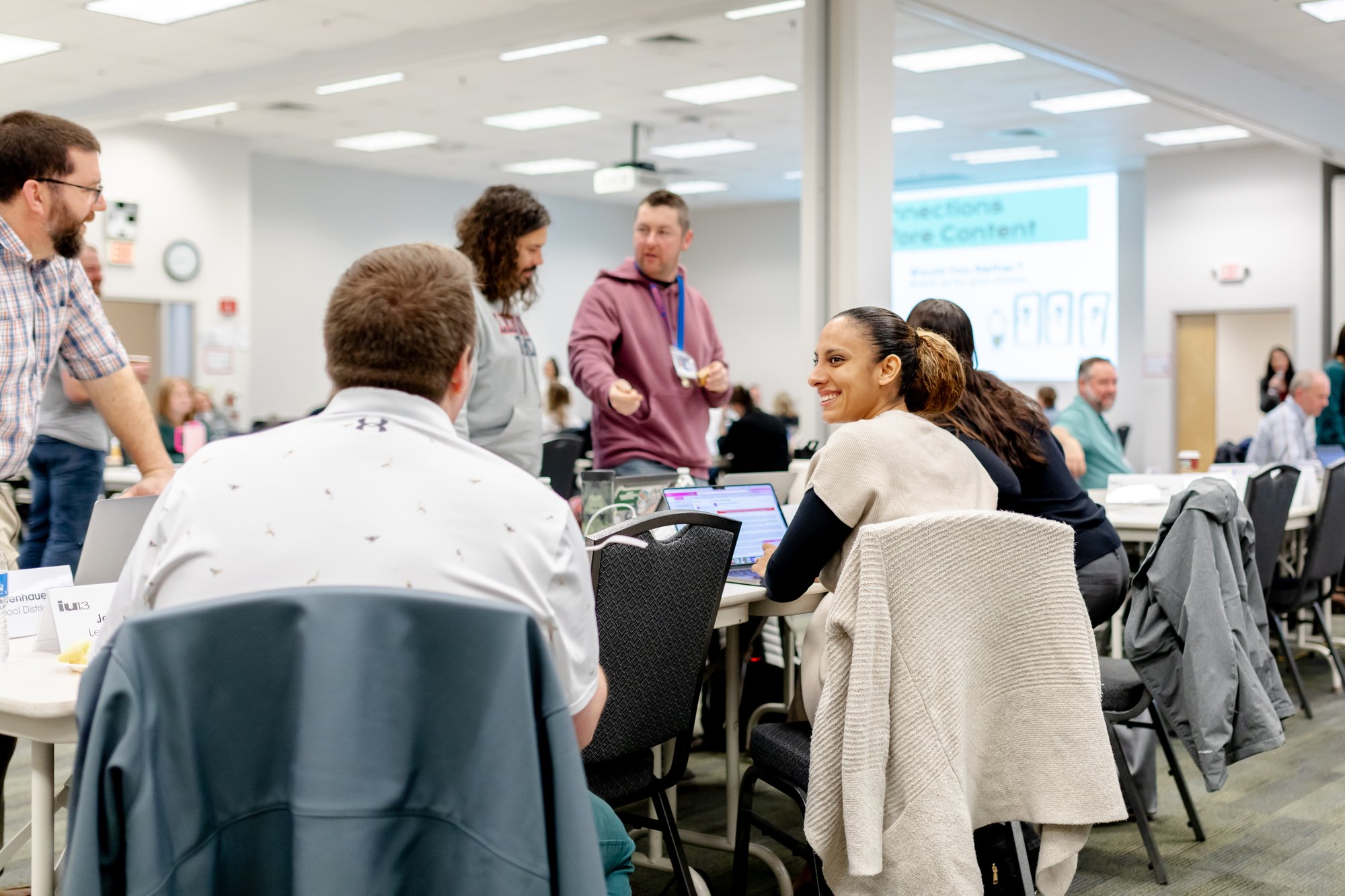 Group of smiling people talking at a conference