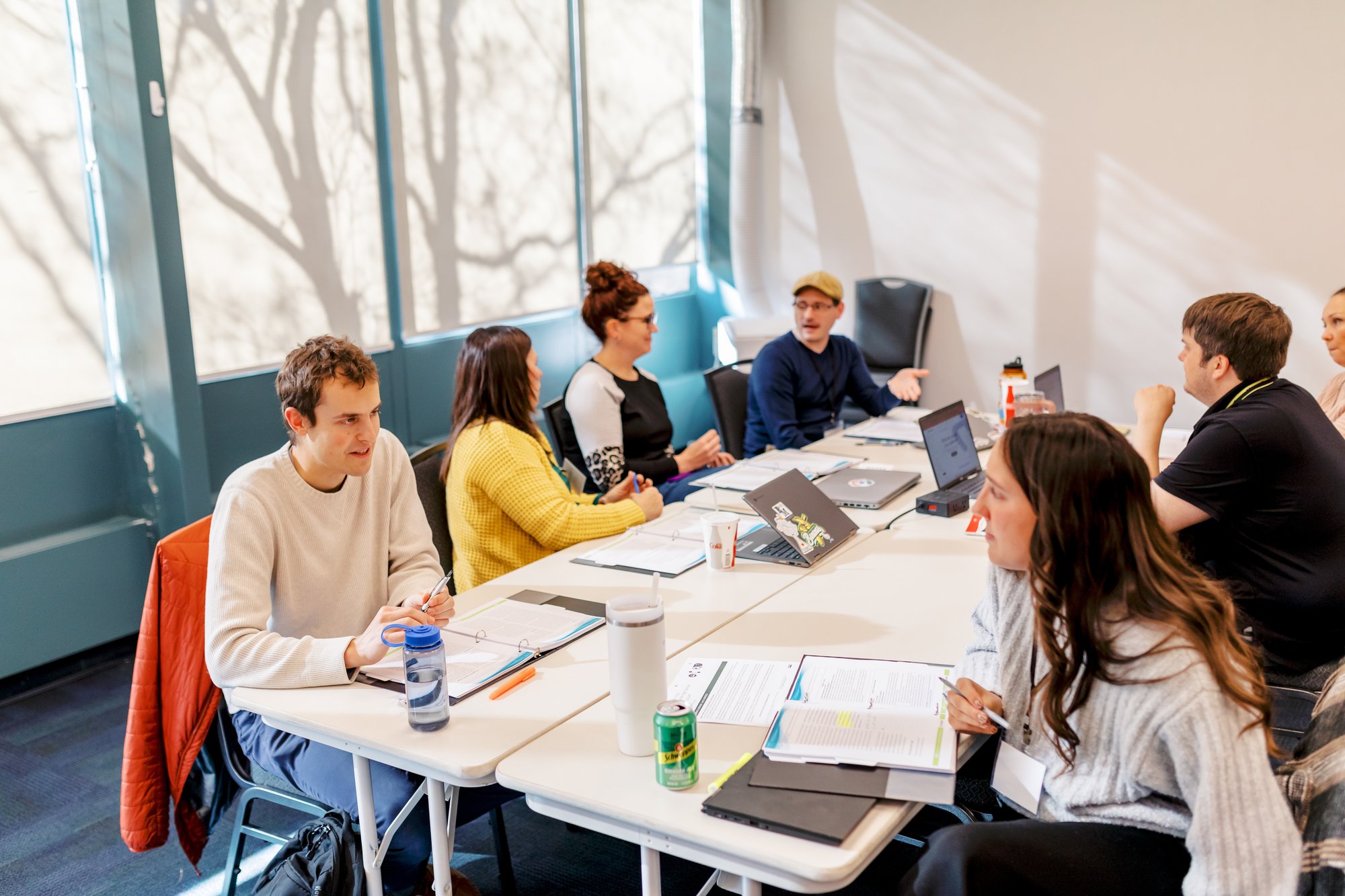 group of people sitting at tables and talking